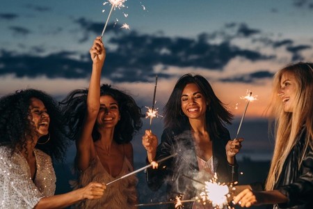 Four happy women celebrating