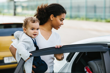 Young mother opening a car door