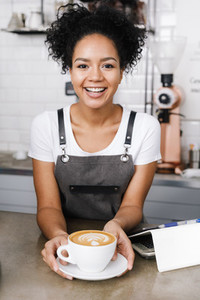 Woman barista in her coffee shop