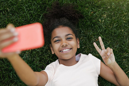 Smiling girl lying on a grass