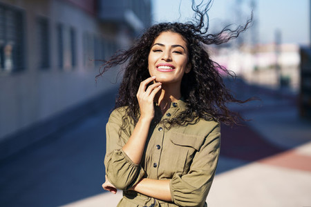 Arab woman with curly hair moved by the wind