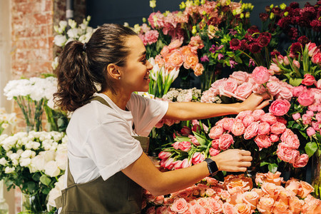 Woman florist picking flower