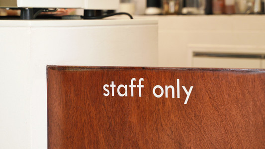 Close up of staff only sign at the wooden door cafe or restauran