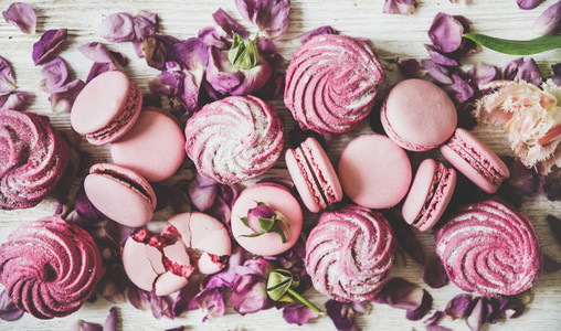 Sweet pink macarons marshmallows and spring flowers and petals