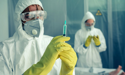 Doctor preparing syringe with virus vaccine