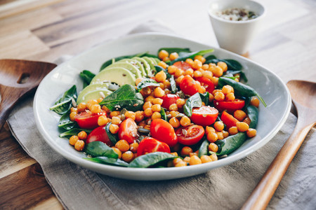 Fresh healthy salad with chickpea  avocado  cherry tomatoes and spinach