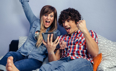 Couple celebrating victory watching sport