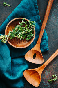 Cooking table background Wooden kitchen tools and bowl with fresh greens
