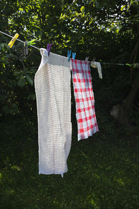 Towels drying on sunny clothesline in backyard