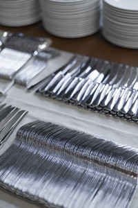 Caterers silverware organized in rows