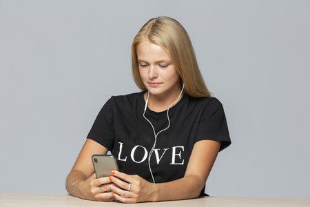 Young woman in love t shirt listening to music