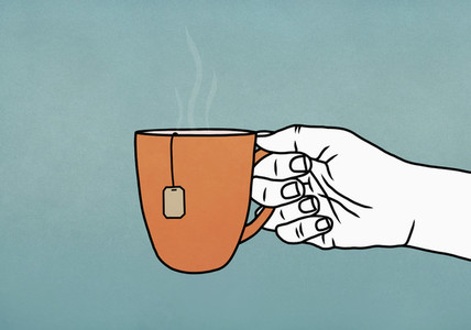 Hand holding mug of hot tea