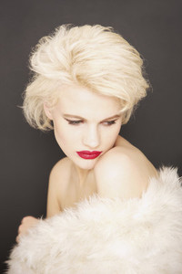 Portrait glamorous blonde woman wrapped in fur