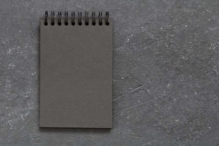 Top view on the blank page of black notepad on the black table  Copy space