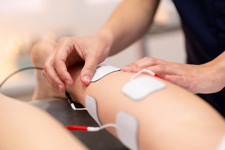 Electro stimulation in physical therapy to a young woman