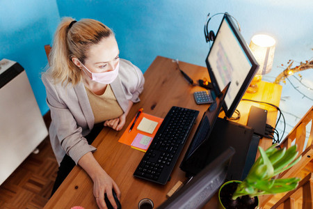 Woman teleworking in her house during biological quarantine