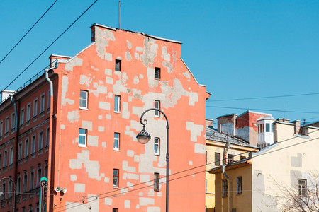 Old houses of European city  Walls of pastel colors with restoration spots