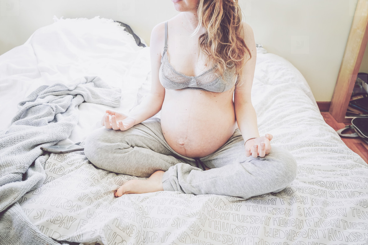 Young pregnant woman alone in home in quarantine