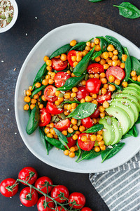 Fresh healthy salad with chickpea avocado cherry tomatoes and spinach