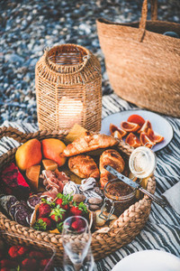 Summer picnic concept with tasty appetizers  fruits and croissants