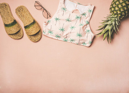 Variety of summer apparel fashionable items and fresh pinapple