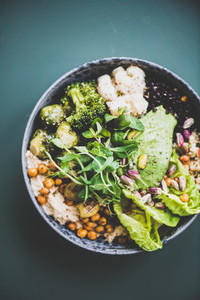 Healthy vegan superbowl and green smoothie on dark background