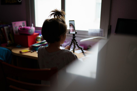 Little girls talking via video conference with smartphone