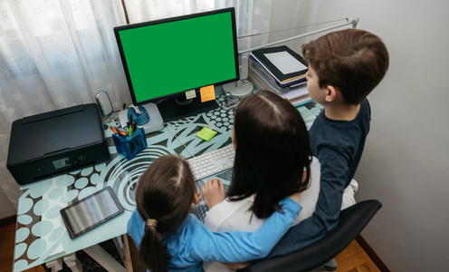 Mother and children looking at computer screen