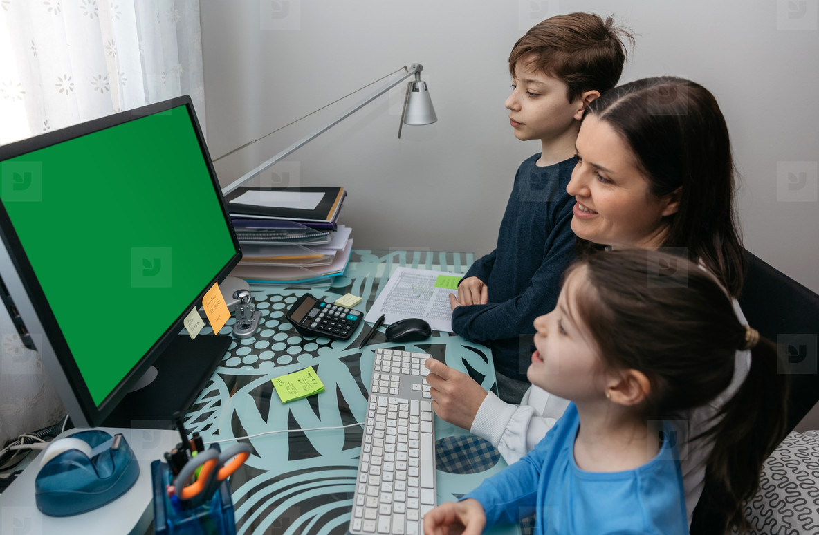 Mother and children looking at computer screen