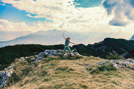Young woman jumping in a mountain