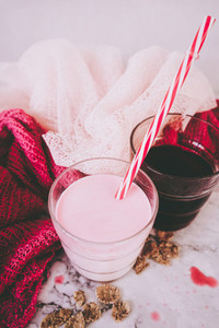 Beautiful composition in pink and white of milkshake and red tea