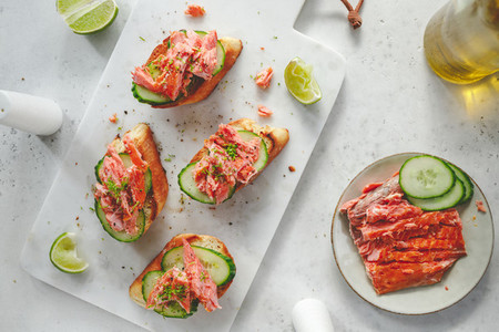 Toasts with fresh cucumber and smoked salmon served with lime shavings
