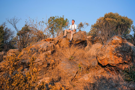Guy sitting on rocky outcrop