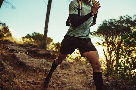 Mountain trail runner practicing on dirt path