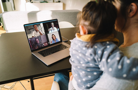 Woman teleconferencing with family on laptop