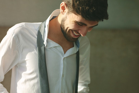 Smiling man getting dressed for office