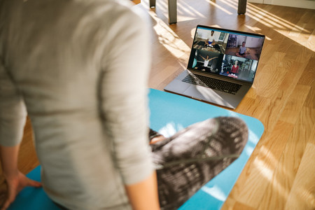 Group of people practicing yoga via video conference