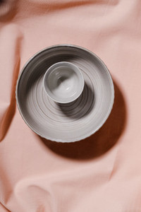 Abstract minimalist still life composition with ceramics over pink cloth