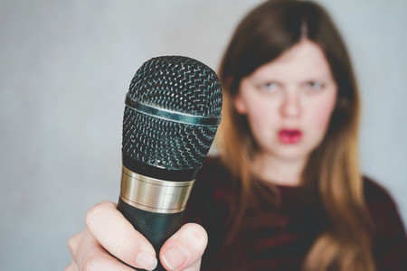 Young woman holding a microphone