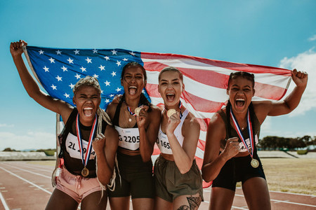 Group of athletes celebrating winning gold