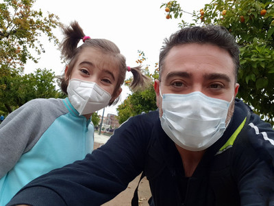 Father and daughter wearing FFP2 and N95 masks on the street