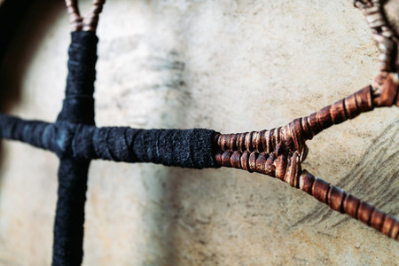 Details of shamanic tambourine  Leather braided handle  handmade  close up view