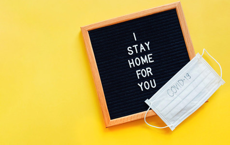 Flat lay of notice board with slogan message I stay home for you