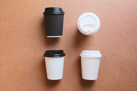 Paper coffee cups take away mock up on wooden background for bus