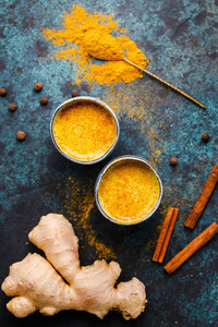Top view of turmeric latte which is made from curcuma  ginger  cinnamon and allspice  Immune and healthcare drink