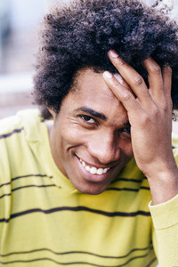 Cuban black tourist with afro hair sitting on the floor