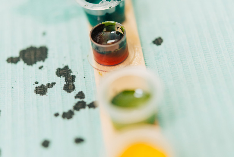 Little tattoo ink bottles full of different colors.