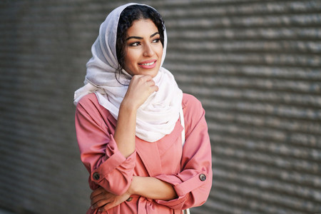 Young Arab woman wearing hijab headscarf walking in the city center
