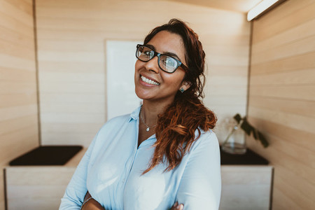 Smiling businesswoman with eyeglasses in office