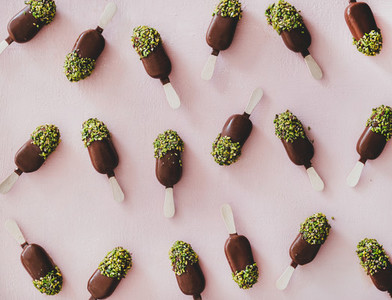 Chocolate glazed ice cream pops with pistachio icing pattern